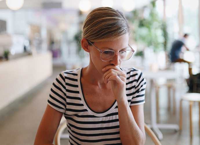Woman in striped shirt thinking